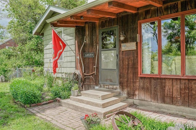 doorway to property featuring fence