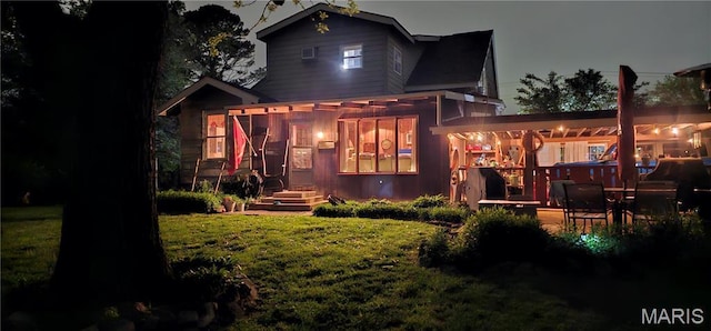 rear view of property with a yard