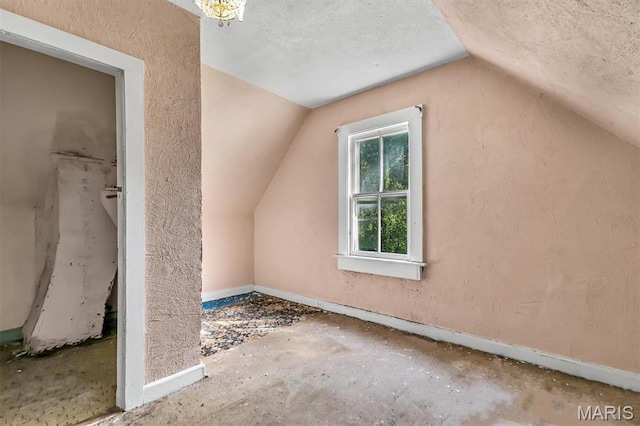 1041 Garth Ave, Saint Louis, MO 63147 - additional living space with lofted ceiling, a textured ceiling, baseboards, and a textured wall
