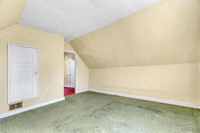 1041 Garth Ave, Saint Louis, MO 63147 - additional living space with vaulted ceiling, carpet, and baseboards
