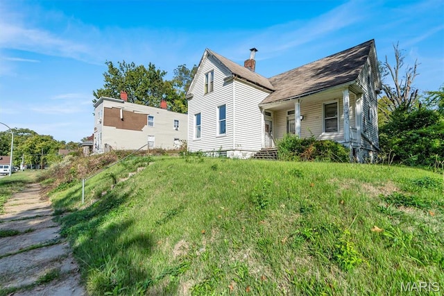 1041 Garth Ave, Saint Louis, MO 63147 - rear view of house featuring a porch and a chimney