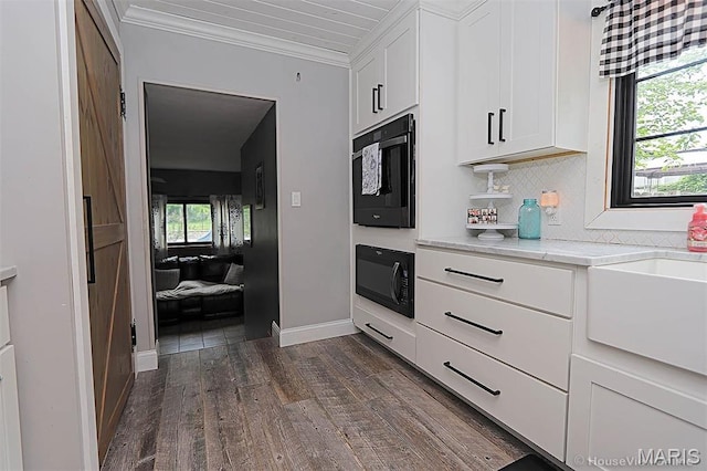 2754 Adeline Ave, Cape Girardeau, MO 63701 - kitchen featuring black microwave, dark wood-style flooring, white cabinets, crown molding, and light stone countertops