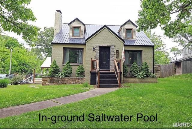 2754 Adeline Ave, Cape Girardeau, MO 63701 - view of front of property with brick siding, a chimney, and a metal roof