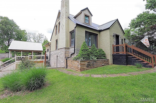 2754 Adeline Ave, Cape Girardeau, MO 63701 - view of side of property featuring a lawn, a metal roof, and a chimney