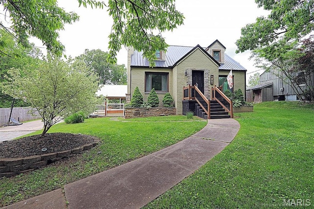 2754 Adeline Ave, Cape Girardeau, MO 63701 - view of front of house featuring a front yard, a metal roof, and brick siding
