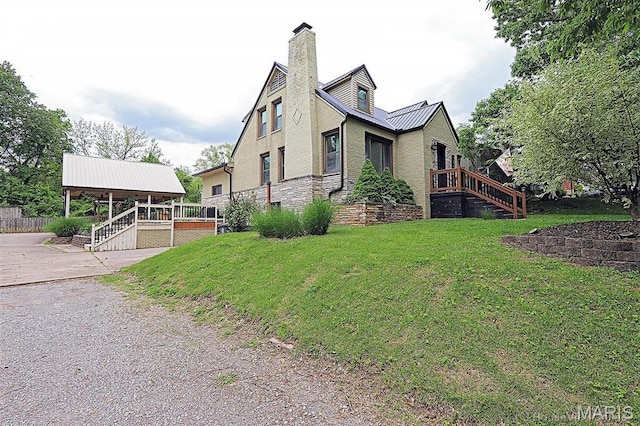 2754 Adeline Ave, Cape Girardeau, MO 63701 - view of property exterior with stairs, a lawn, a metal roof, a chimney, and concrete driveway