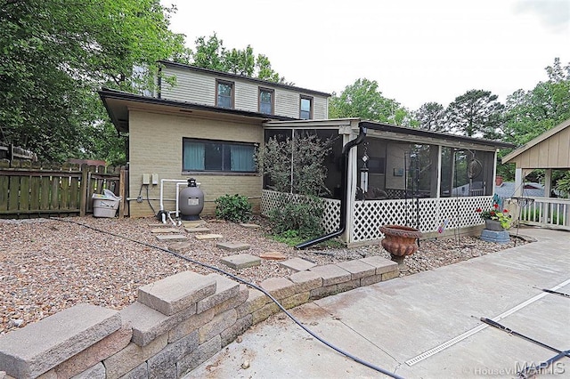 2754 Adeline Ave, Cape Girardeau, MO 63701 - rear view of property featuring a sunroom and a patio
