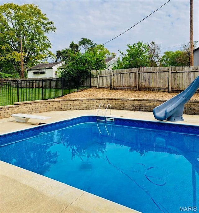 2754 Adeline Ave, Cape Girardeau, MO 63701 - view of swimming pool featuring a water slide, a fenced backyard, and a diving board