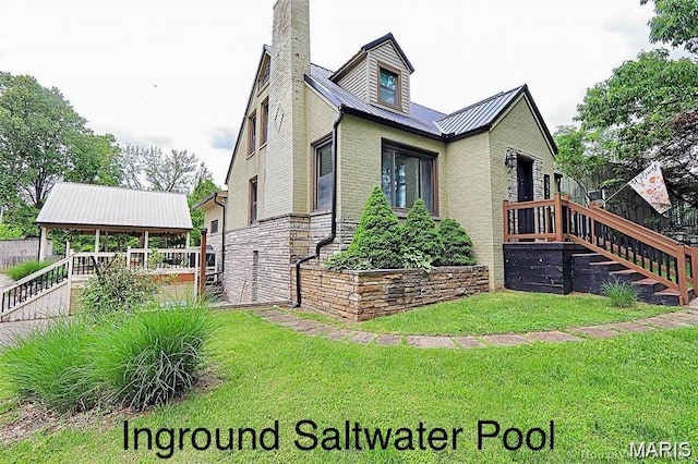 2754 Adeline Ave, Cape Girardeau, MO 63701 - view of side of home featuring a lawn, a metal roof, and a chimney