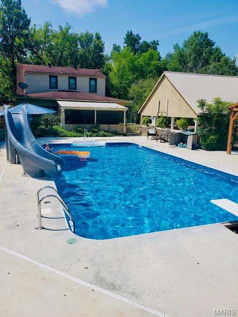2754 Adeline Ave, Cape Girardeau, MO 63701 - view of swimming pool with a water slide, a diving board, a gazebo, and a patio area