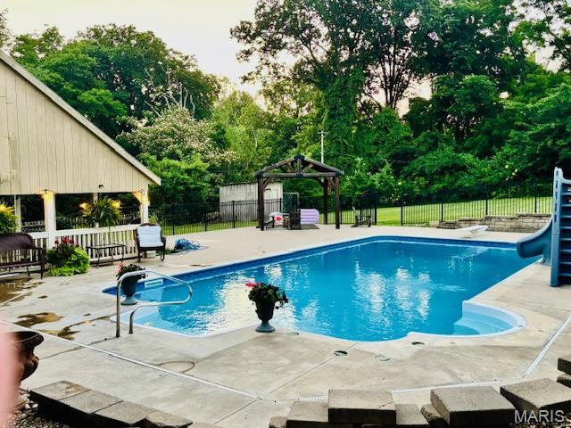 2754 Adeline Ave, Cape Girardeau, MO 63701 - view of pool featuring a gazebo, a water slide, view of wooded area, and a patio