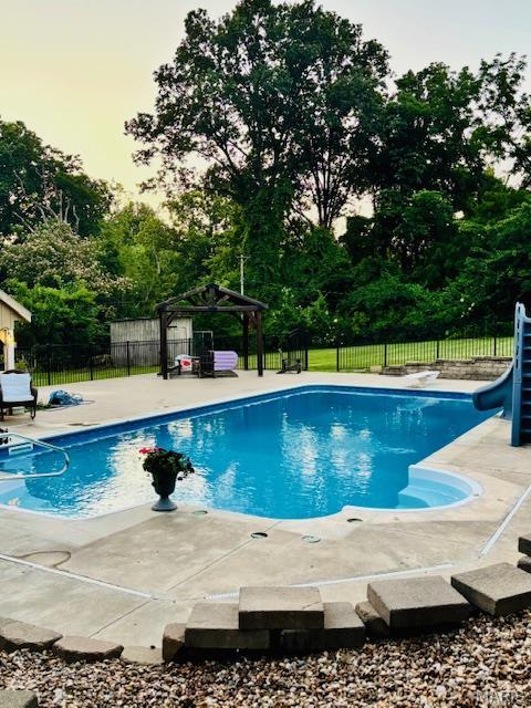 2754 Adeline Ave, Cape Girardeau, MO 63701 - view of pool with a water slide, a gazebo, view of scattered trees, and a patio