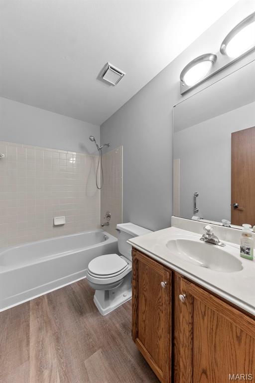 324 Trailview Ave, Saint Peters, MO 63376 - full bathroom featuring wood finished floors, vanity, toilet, and shower / tub combination