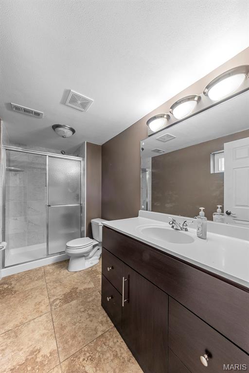 324 Trailview Ave, Saint Peters, MO 63376 - full bath featuring vanity, a stall shower, toilet, and tile patterned flooring