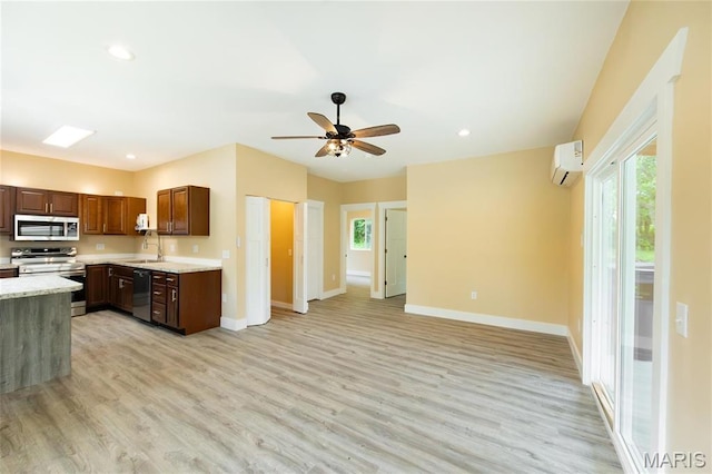 408 E Roosevelt, Salem, MO 65560 - kitchen featuring stainless steel appliances, an AC wall unit, light wood-style flooring, baseboards, and open floor plan
