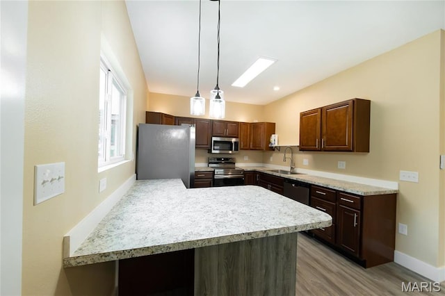 408 E Roosevelt, Salem, MO 65560 - kitchen with stainless steel appliances, a sink, light countertops, a peninsula, and light wood-type flooring