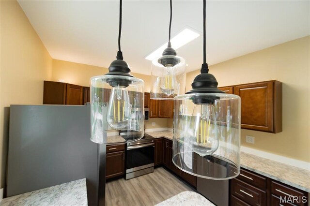408 E Roosevelt, Salem, MO 65560 - kitchen view of stainless steel appliances, light wood-style flooring, light stone countertops, and hanging light fixtures