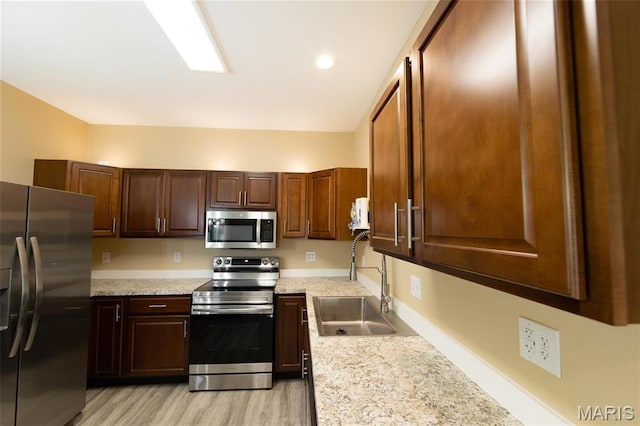 408 E Roosevelt, Salem, MO 65560 - kitchen with appliances with stainless steel finishes, a sink, light countertops, and light wood-style flooring