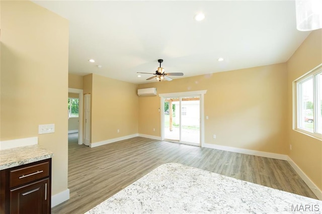 408 E Roosevelt, Salem, MO 65560 - unfurnished room with a wall mounted air conditioner, light wood-style flooring, a ceiling fan, recessed lighting, and baseboards