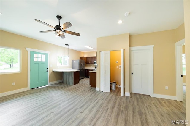 408 E Roosevelt, Salem, MO 65560 - unfurnished living room featuring light wood-type flooring, baseboards, and a ceiling fan
