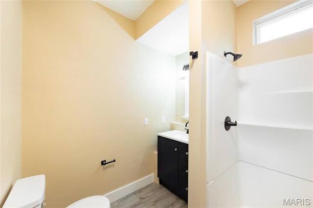 408 E Roosevelt, Salem, MO 65560 - full bath featuring toilet, a shower, wood finished floors, vanity, and baseboards