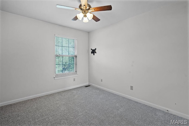 empty room featuring ceiling fan, carpet floors, and baseboards