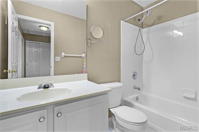 bathroom featuring toilet, vanity, and shower / bathtub combination