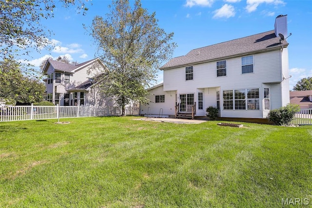 rear view of property featuring a chimney and a patio