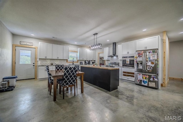 22950 Pin Oak Dr, Lebanon, MO 65536 - kitchen featuring appliances with stainless steel finishes, wall chimney exhaust hood, backsplash, white cabinets, and finished concrete floors