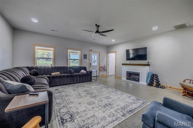 22950 Pin Oak Dr, Lebanon, MO 65536 - living room featuring a ceiling fan, a fireplace, baseboards, recessed lighting, and concrete flooring