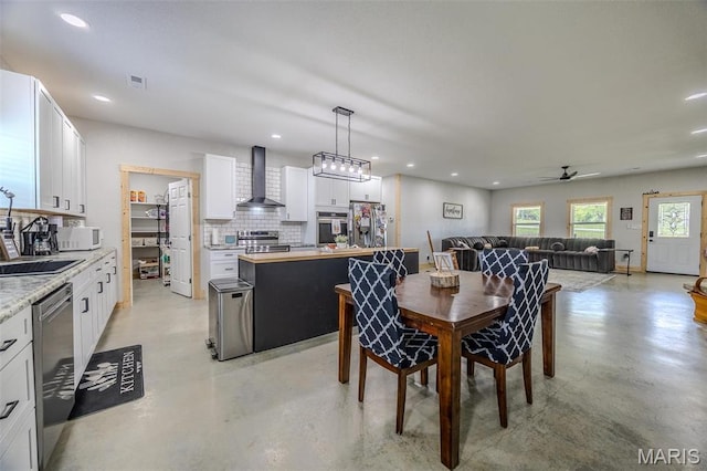 22950 Pin Oak Dr, Lebanon, MO 65536 - dining area featuring finished concrete floors, a ceiling fan, and recessed lighting