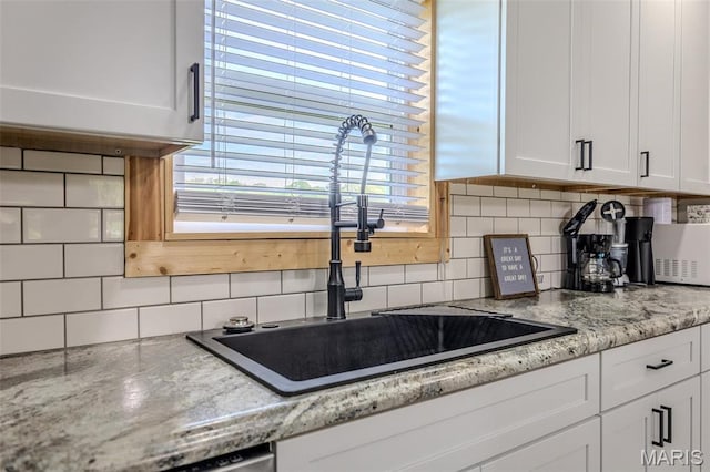 22950 Pin Oak Dr, Lebanon, MO 65536 - kitchen featuring a sink, white cabinetry, decorative backsplash, and light stone countertops