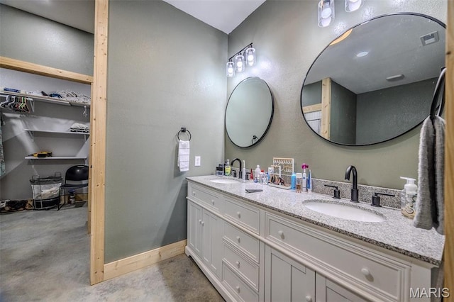 22950 Pin Oak Dr, Lebanon, MO 65536 - full bath with concrete floors, double vanity, a walk in closet, and baseboards