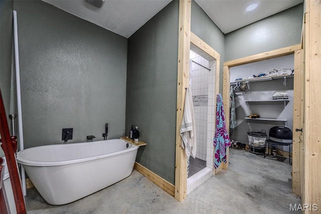 22950 Pin Oak Dr, Lebanon, MO 65536 - full bathroom with unfinished concrete flooring, a stall shower, a spacious closet, and a freestanding bath