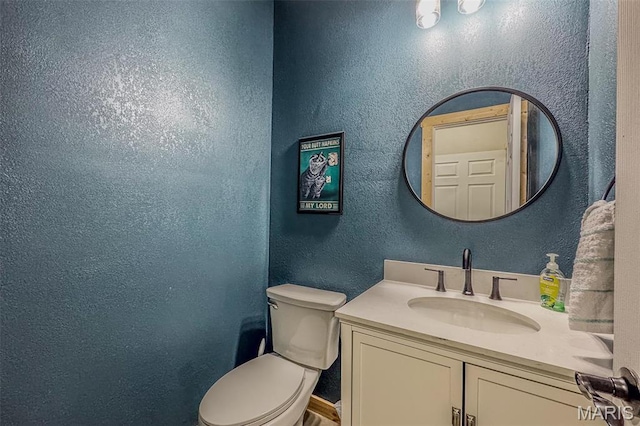 22950 Pin Oak Dr, Lebanon, MO 65536 - half bathroom featuring a textured wall, toilet, and vanity