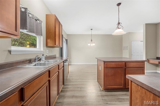 554 Springhurst Pkwy, Ofallon, MO 63368 - kitchen with a sink, stainless steel dishwasher, light wood-style floors, a chandelier, and brown cabinets