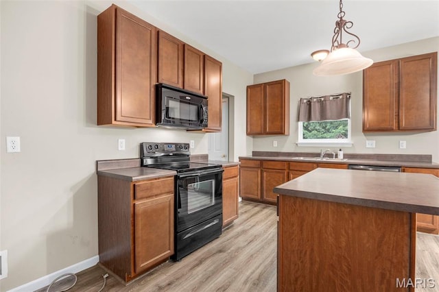 554 Springhurst Pkwy, Ofallon, MO 63368 - kitchen with black appliances, light wood-style flooring, brown cabinets, and pendant lighting