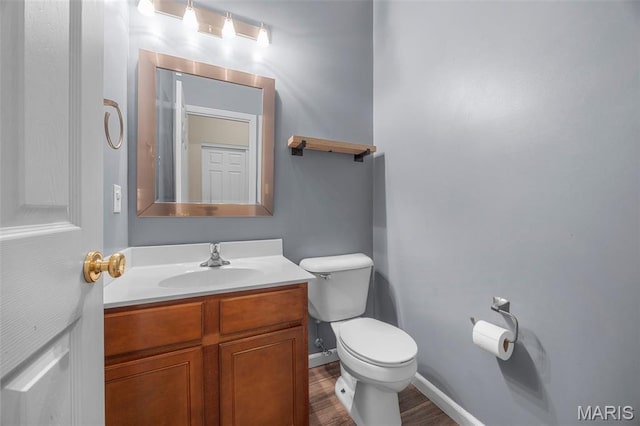 554 Springhurst Pkwy, Ofallon, MO 63368 - bathroom featuring toilet, vanity, wood finished floors, and baseboards