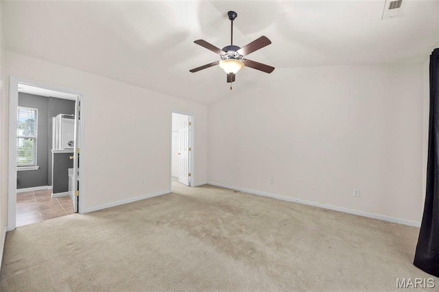 554 Springhurst Pkwy, Ofallon, MO 63368 - empty room featuring light carpet, a ceiling fan, lofted ceiling, and baseboards