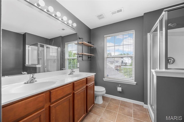 554 Springhurst Pkwy, Ofallon, MO 63368 - bathroom featuring a stall shower, double vanity, toilet, baseboards, and tile patterned floors