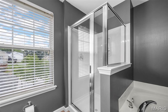554 Springhurst Pkwy, Ofallon, MO 63368 - full bath featuring a shower stall, plenty of natural light, and a garden tub