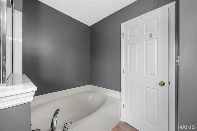554 Springhurst Pkwy, Ofallon, MO 63368 - bathroom with a bath and tile patterned floors