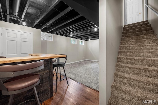 554 Springhurst Pkwy, Ofallon, MO 63368 - indoor dry bar with stairway, wood finished floors, and baseboards