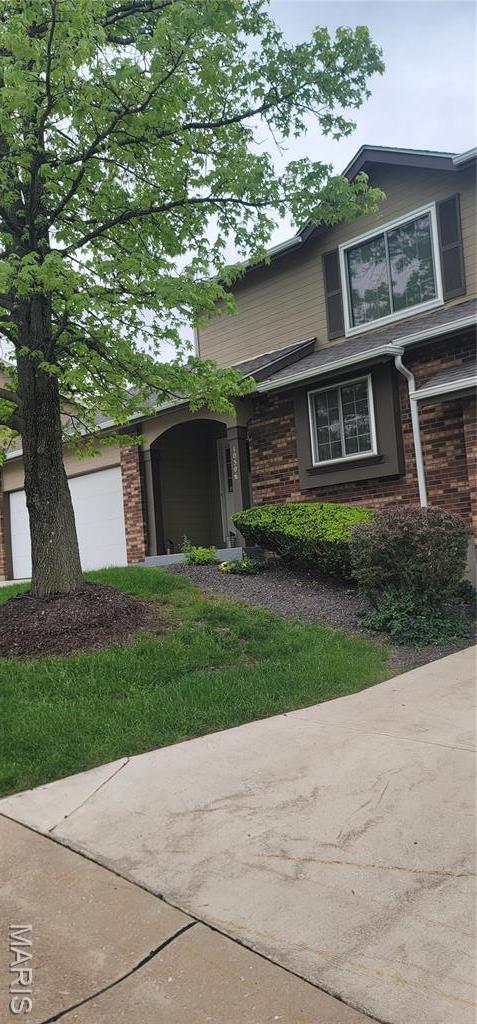10506 Camden Park Dr, Saint Louis, MO 63135 - view of front of property featuring an attached garage and brick siding
