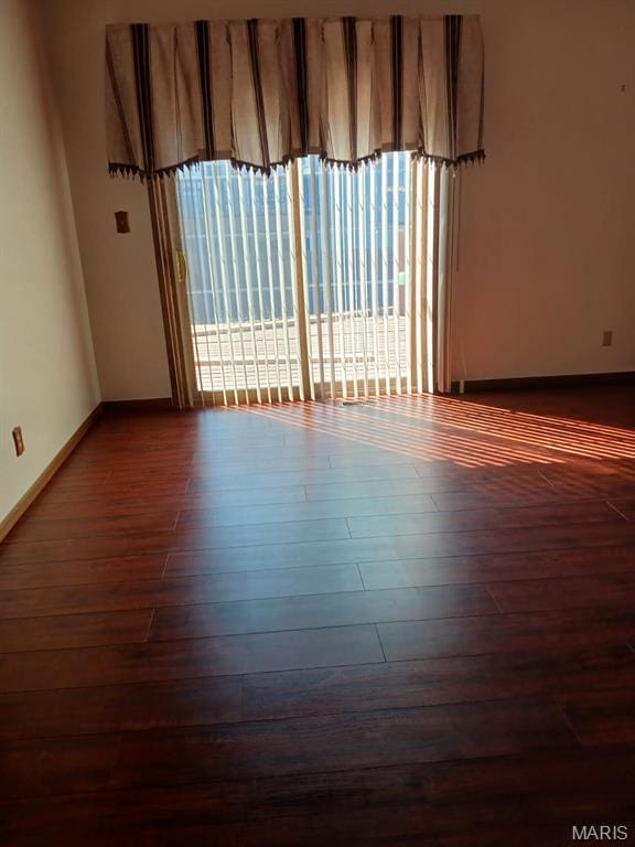 10506 Camden Park Dr, Saint Louis, MO 63135 - unfurnished room with dark wood-style flooring and baseboards