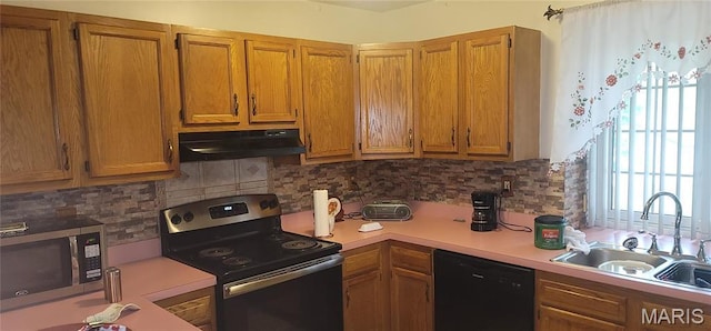 10506 Camden Park Dr, Saint Louis, MO 63135 - kitchen featuring stainless steel appliances, under cabinet range hood, a sink, light countertops, and brown cabinets