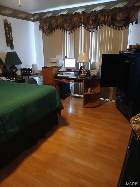 10506 Camden Park Dr, Saint Louis, MO 63135 - bedroom featuring light wood-style flooring and an office area