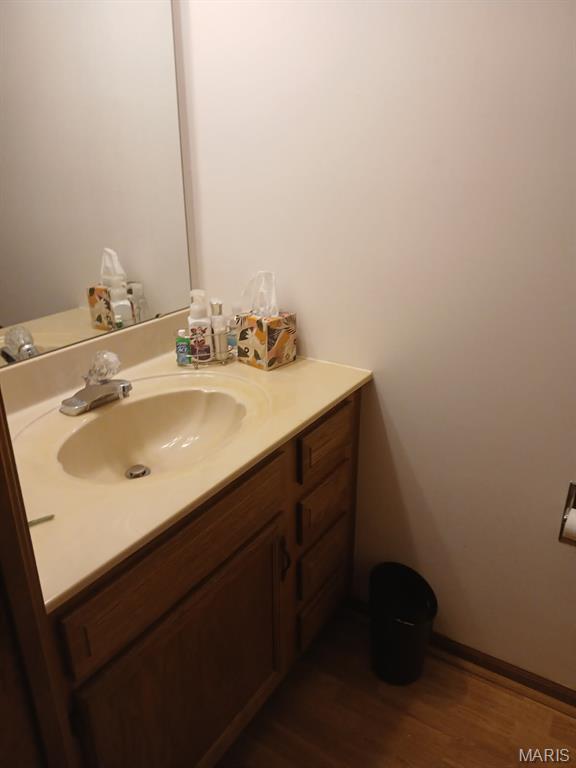 10506 Camden Park Dr, Saint Louis, MO 63135 - bathroom featuring vanity and wood finished floors