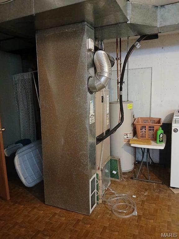 10506 Camden Park Dr, Saint Louis, MO 63135 - utility room featuring electric water heater and heating unit