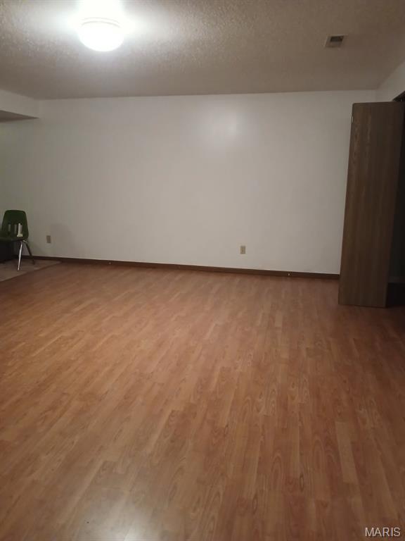 10506 Camden Park Dr, Saint Louis, MO 63135 - unfurnished room with light wood-style floors and baseboards